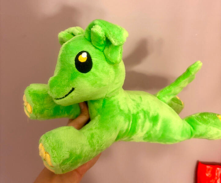 green dog with alien antenna and yellow paw pads