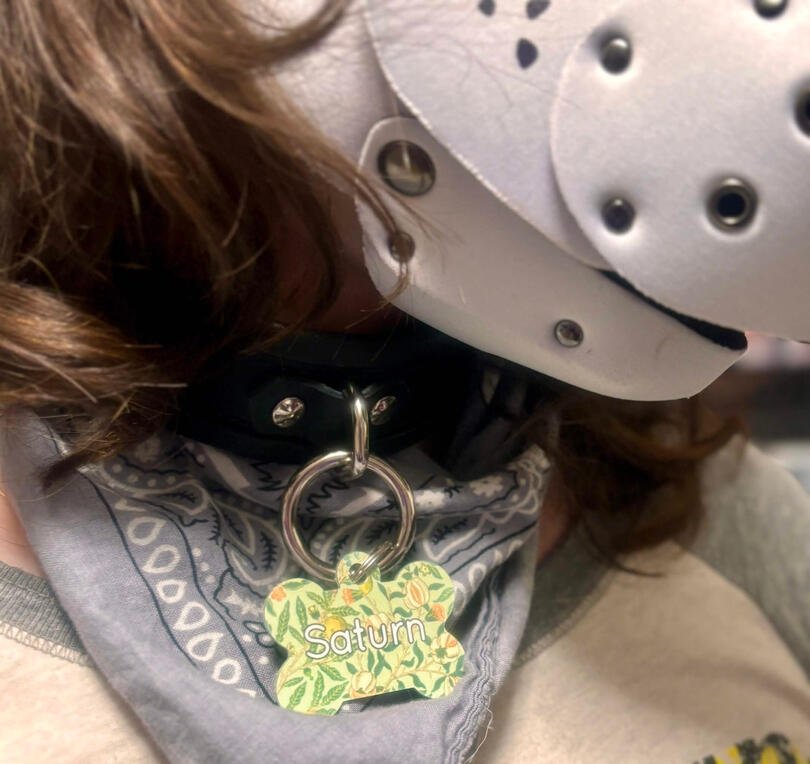 Custom dog tag on pup hood wearer